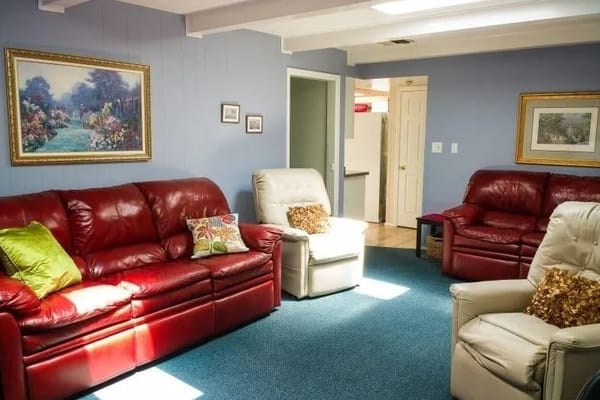 Cozy common area with red sofas and artwork