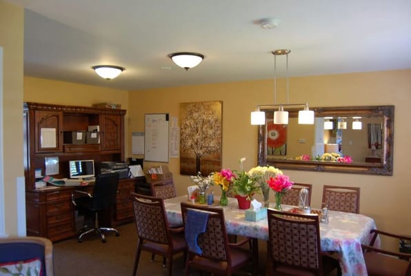 Dining area with flowers and a desk