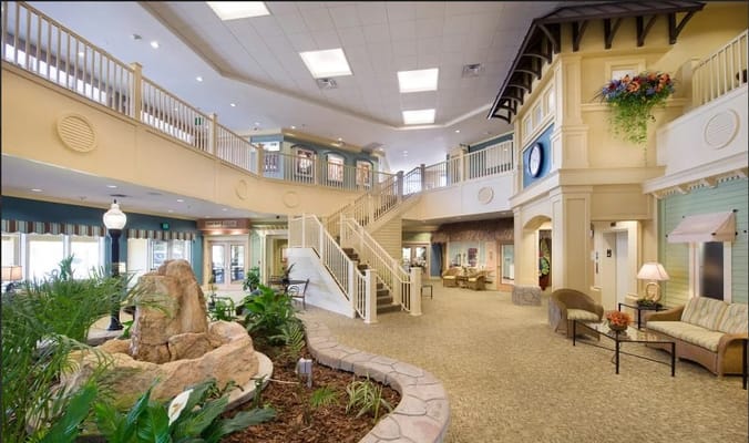 Bright, spacious lobby area with seating and plants
