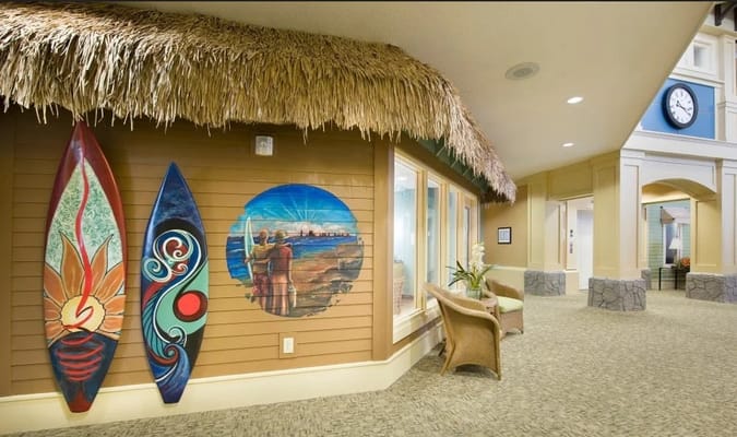 Interior view of a decorated common area with surfboards
