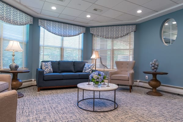 Cozy common area with seating, flowers, and natural light