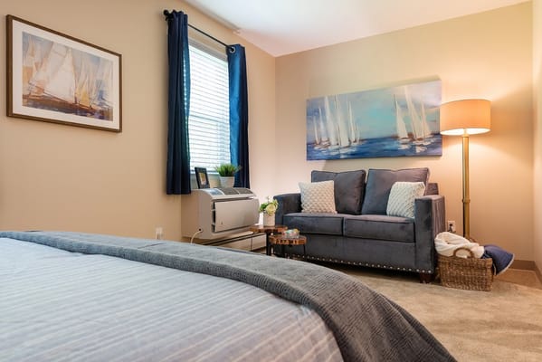 Cozy interior of a resident room with a couch and artwork