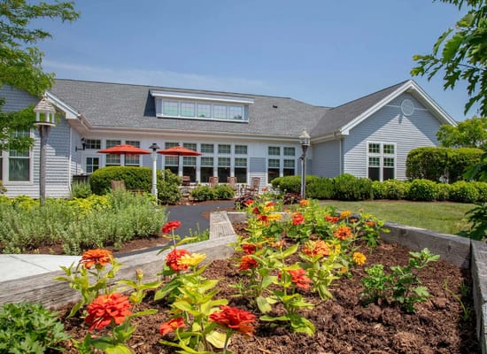 Exterior view of a senior living facility with garden