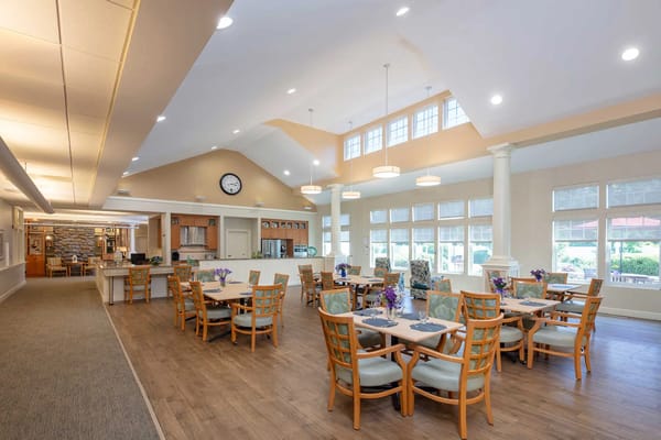 Dining area with tables and chairs, bright lighting