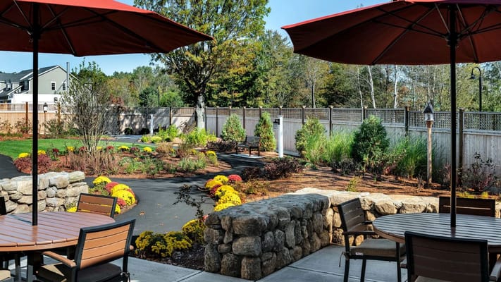 Garden area with seating and umbrellas in outdoor space