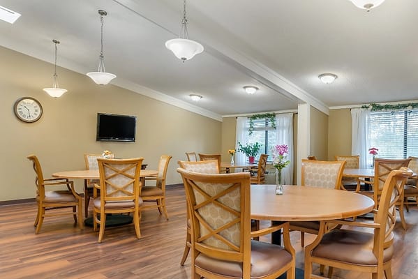 Bright dining area with wooden tables and chairs