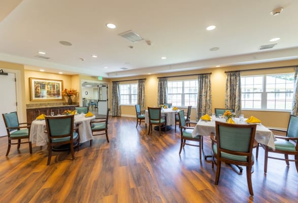 Spacious dining area with tables set for meals