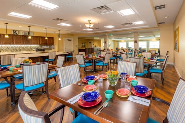 Brightly decorated dining room with tables set for a meal.