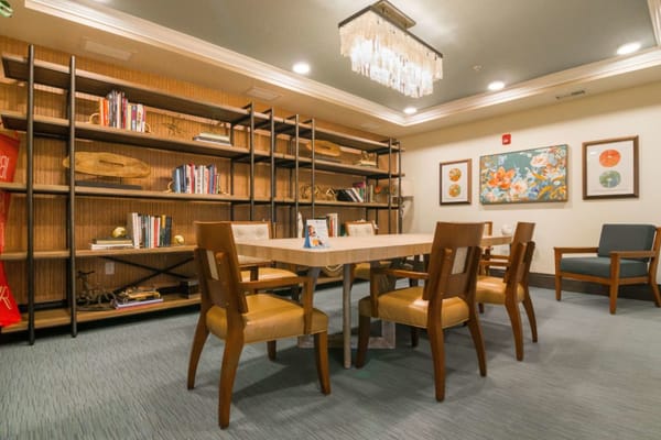 Common area with a table and bookshelves