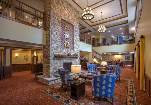 Cozy common area with stone fireplace and seating