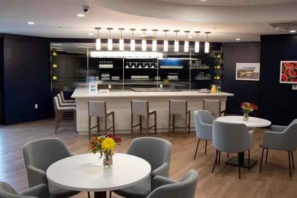 Bright common area with seating and a bar