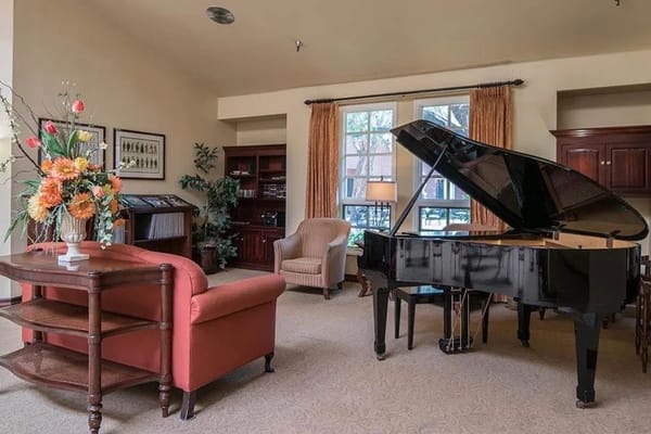 Interior space with a grand piano and seating area