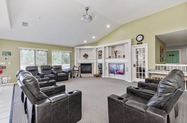 Spacious living room with recliner seating and a fireplace.