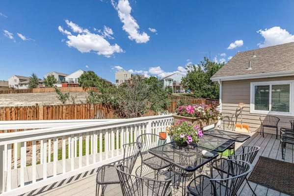 View of outdoor deck with seating and flowers