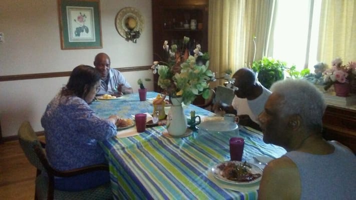 Residents enjoying a meal together in the dining area.