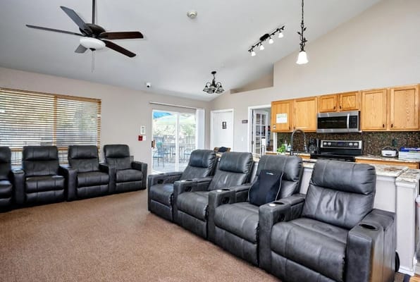 Cozy common area with reclining chairs and kitchen