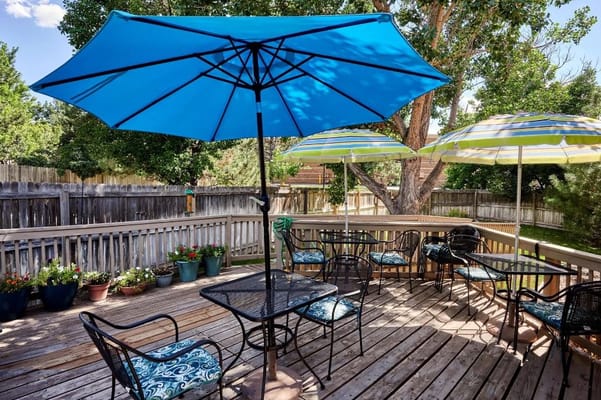 Outdoor seating area with umbrellas and flower pots