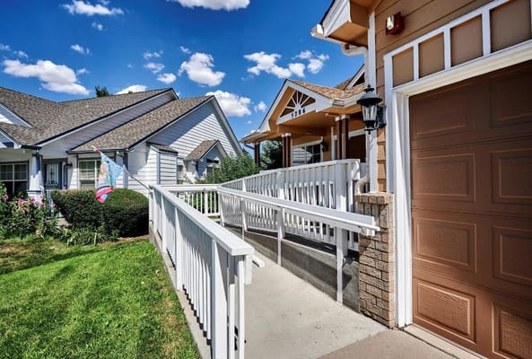 Exterior view of a senior living facility entrance with ramp