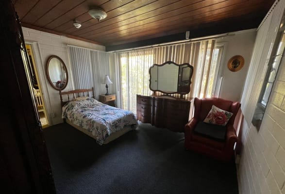 Cozy private room with a bed and armchair