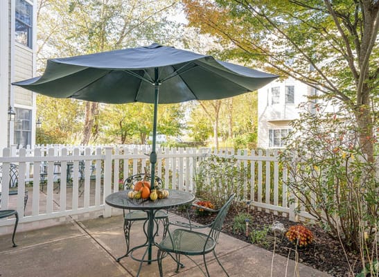 Quiet outdoor seating area with table and umbrellas