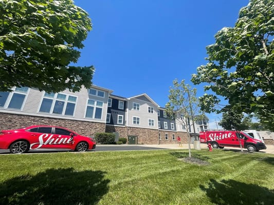 Exterior view of the facility with branded vehicles