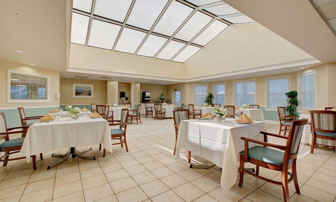 Brightly lit dining area with tables set for meals