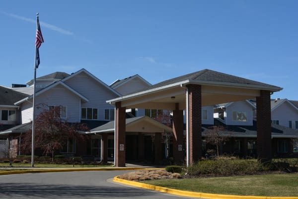 Front entrance of StoryPoint Grand Rapids West with American flag