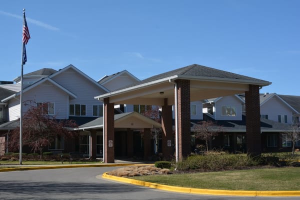 Main entrance of StoryPoint Grand Rapids West with covered porch and flagpole
