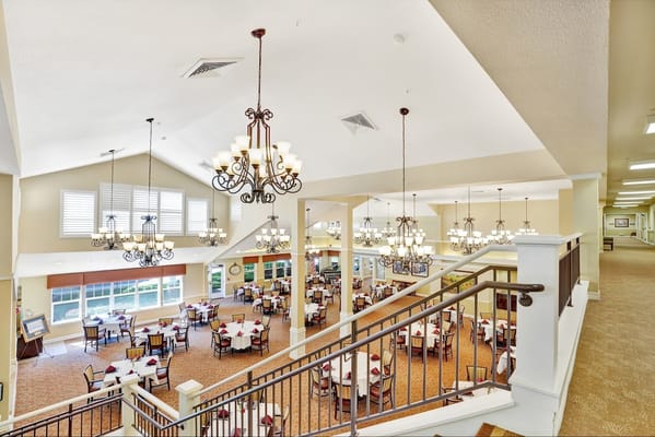 View of the dining room at Dale Commons with chandeliers and tables set