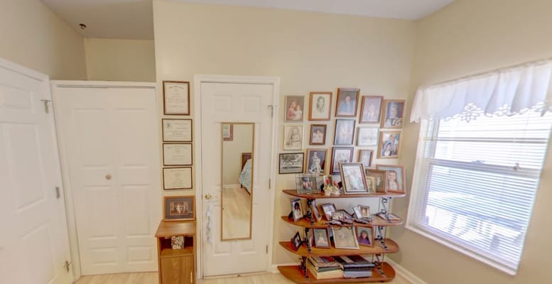 Interior of a resident's room with family photos and awards on display.