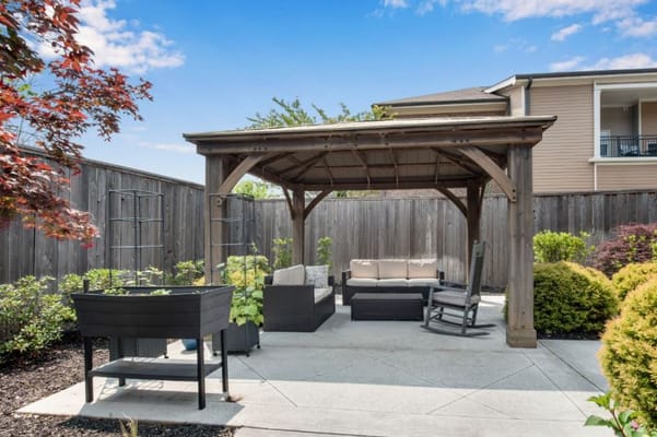 Outdoor seating area with a gazebo and plants