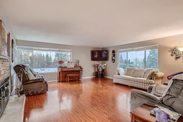 Bright common area with a piano and large windows