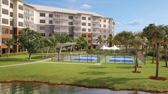 Outdoor view of the facility with tennis courts and landscaping