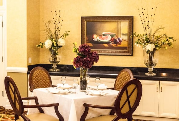 Elegant dining area with floral arrangements and table setting
