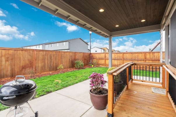 View of an outdoor space with a grill and garden