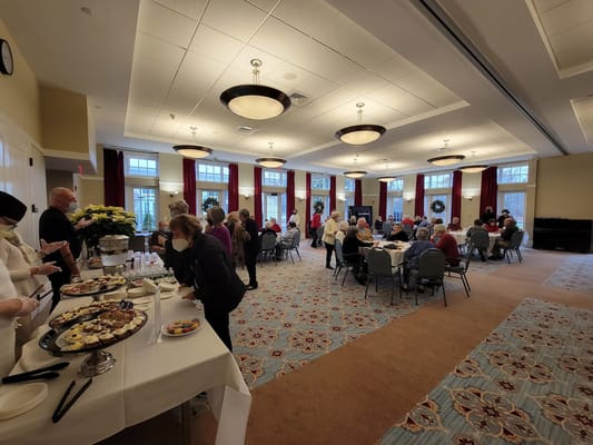 Residents enjoying a gathering with refreshments in a common area