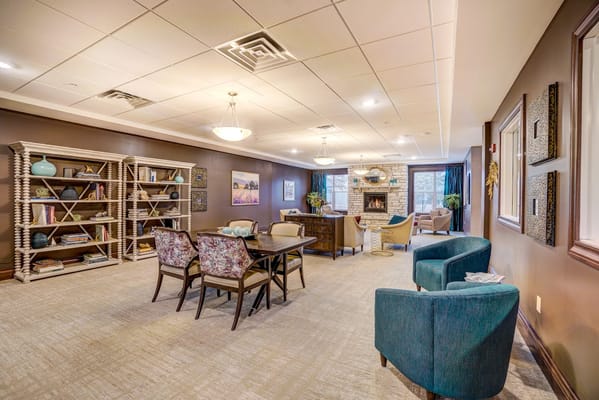 Common area with comfortable seating and library shelves