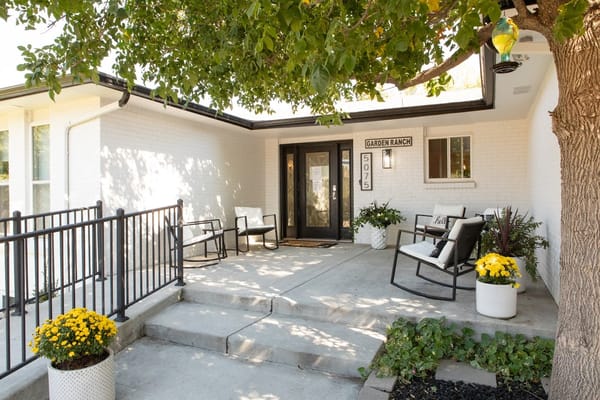 Entrance of Garden Ranch Assisted Living with outdoor seating.