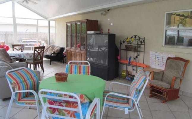 Colorful chairs and a table in an outdoor lounge area.