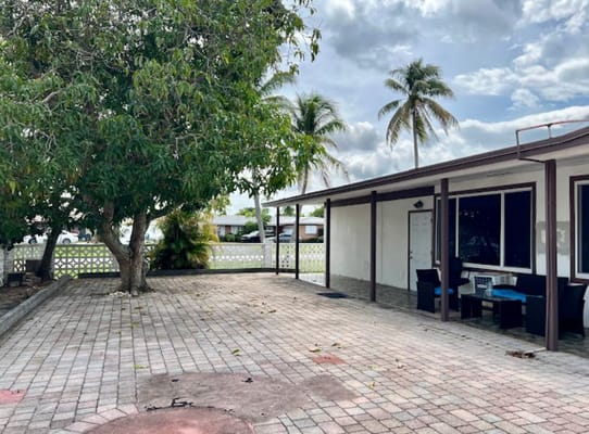 Outdoor patio area with seating and greenery