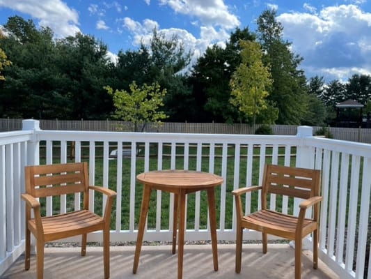 Empty outdoor seating area with chairs and table