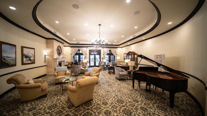 Lounge area with seating and a grand piano at Grand Living At Tamaya