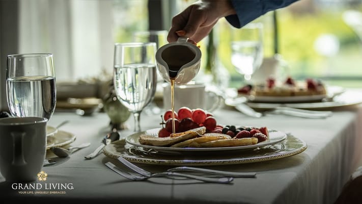 Elegant dining setup with pancakes and fresh fruit