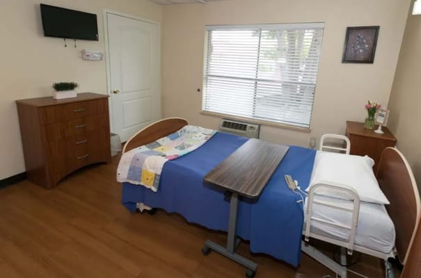 A private resident room with bed and furniture
