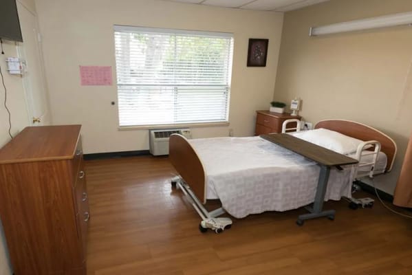 Private resident room with bed and dresser