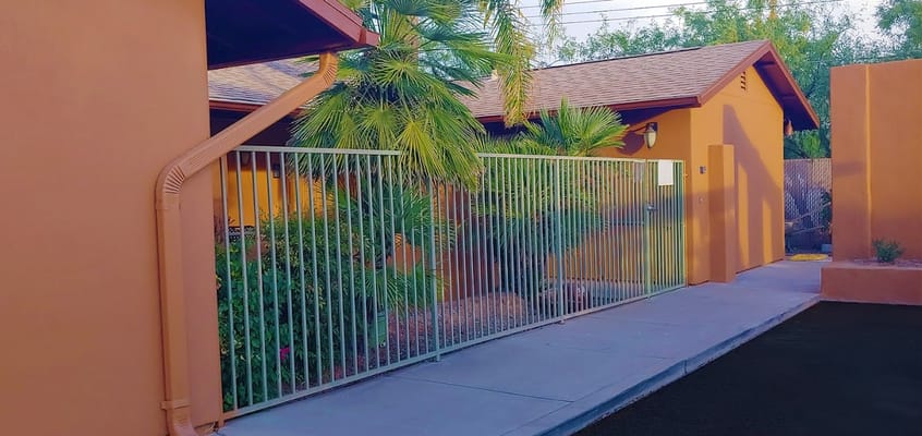 Exterior view of the facility with landscaping and fence