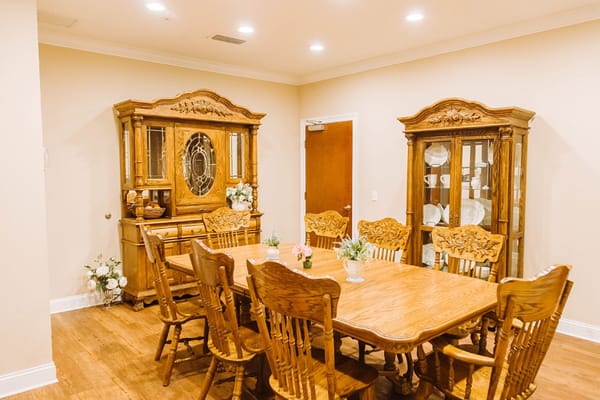 Dining area with a large wooden table and chairs