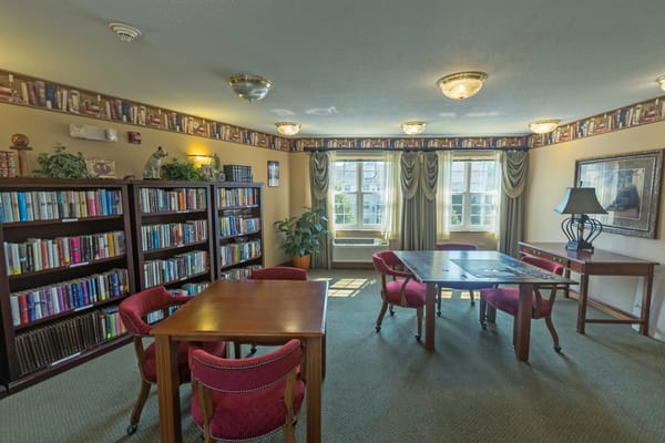Cozy reading room with shelves of books and tables