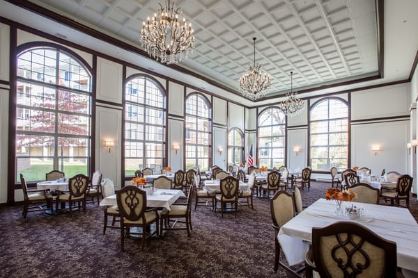 Elegant dining room with chandeliers and large windows