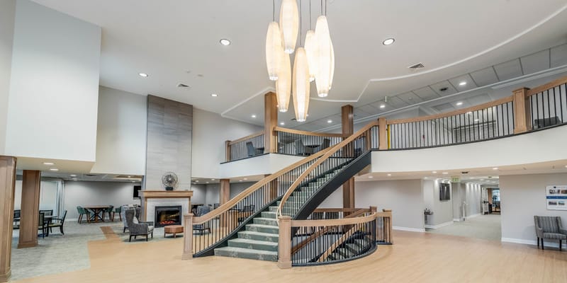 Spacious lobby with staircase and fireplace